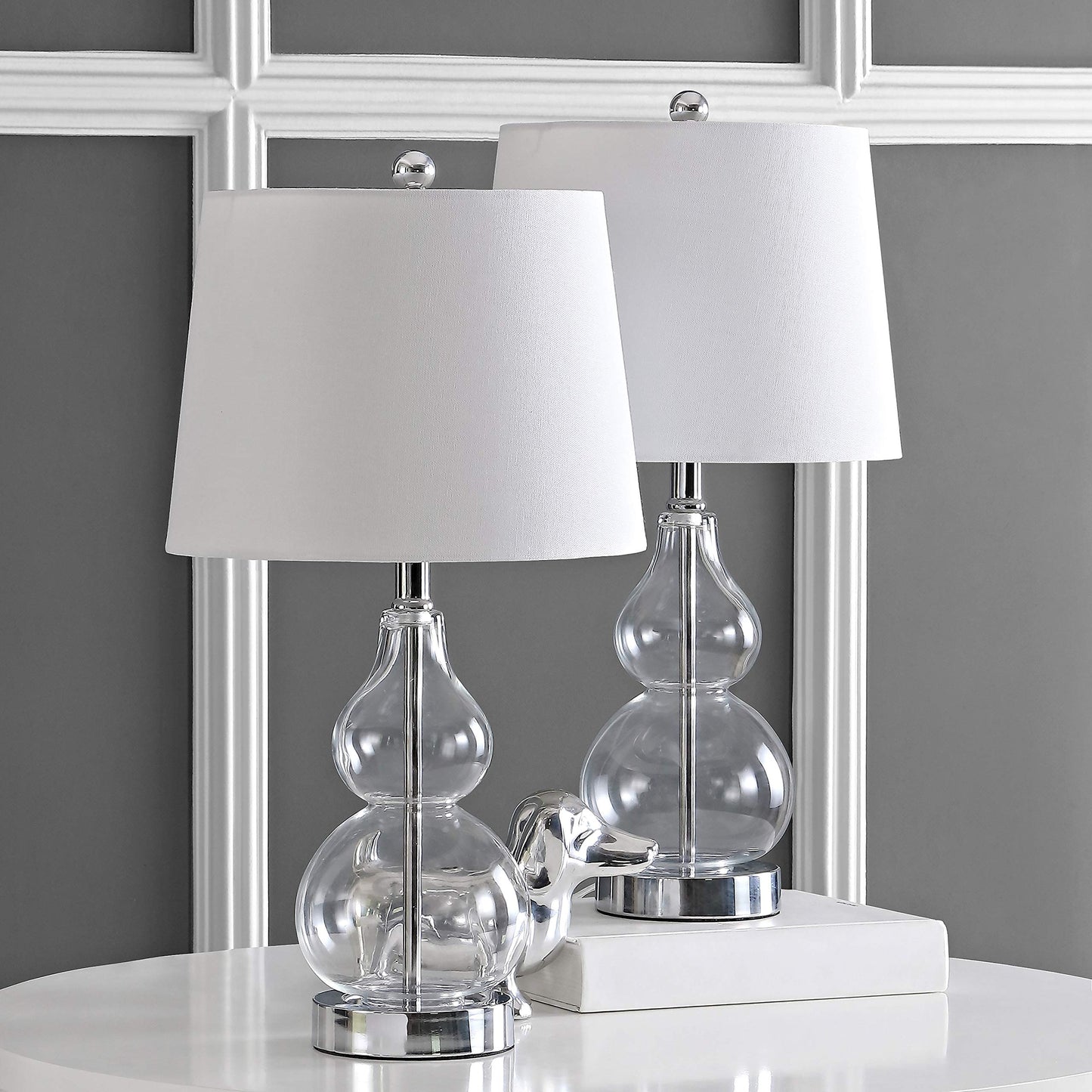 Elegant clear glass double‑gourd table lamp atop a polished chrome base, standing approximately 22 inches tall with a crisp white shade-1